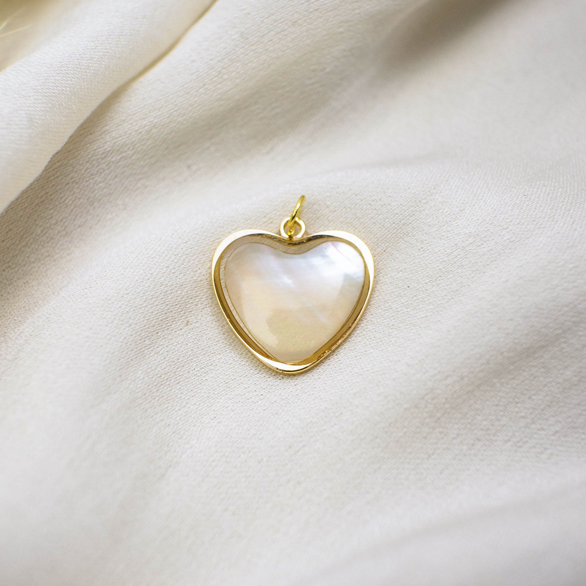 This photo features with a heart-shaped pendant made of pearl paper.