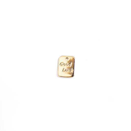 This photo features with a rectangular tag pendant with the words 'good luck'.