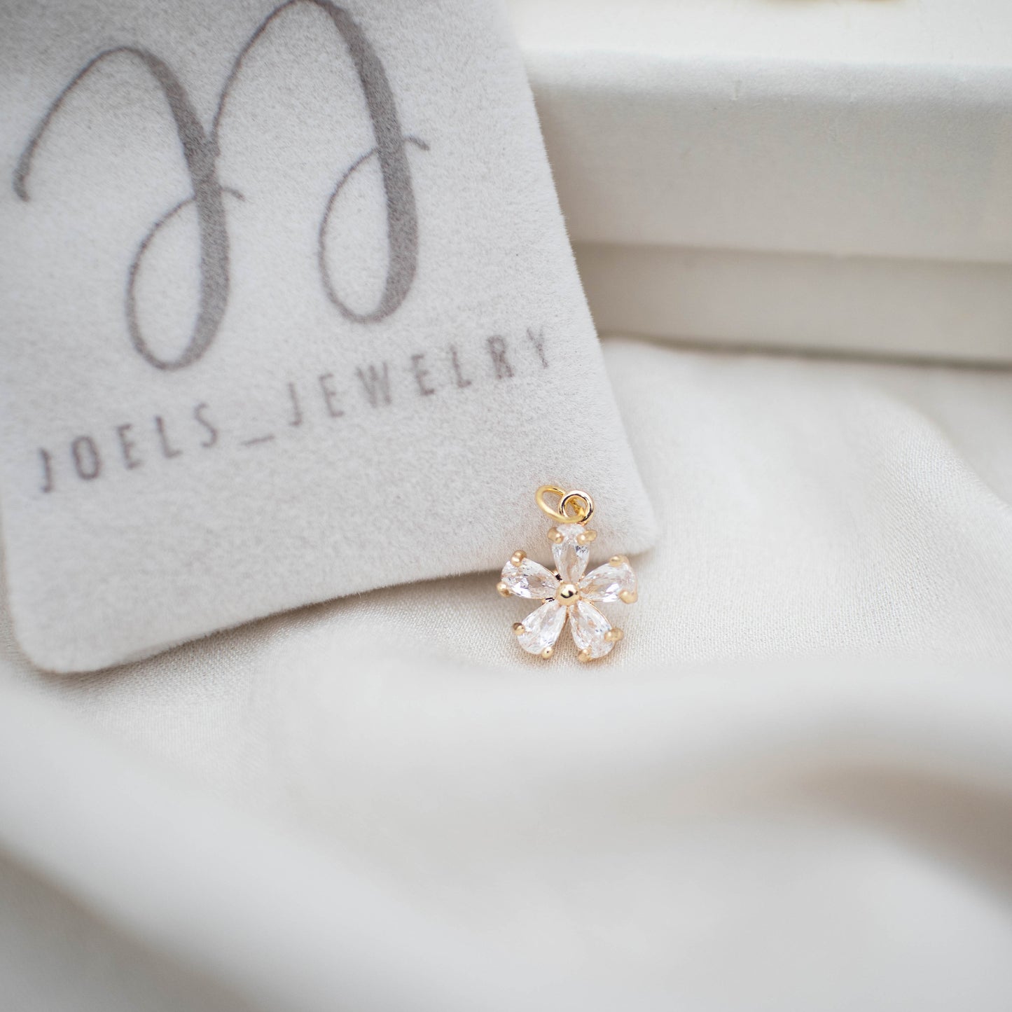This photo features with a zircon  flower charm.