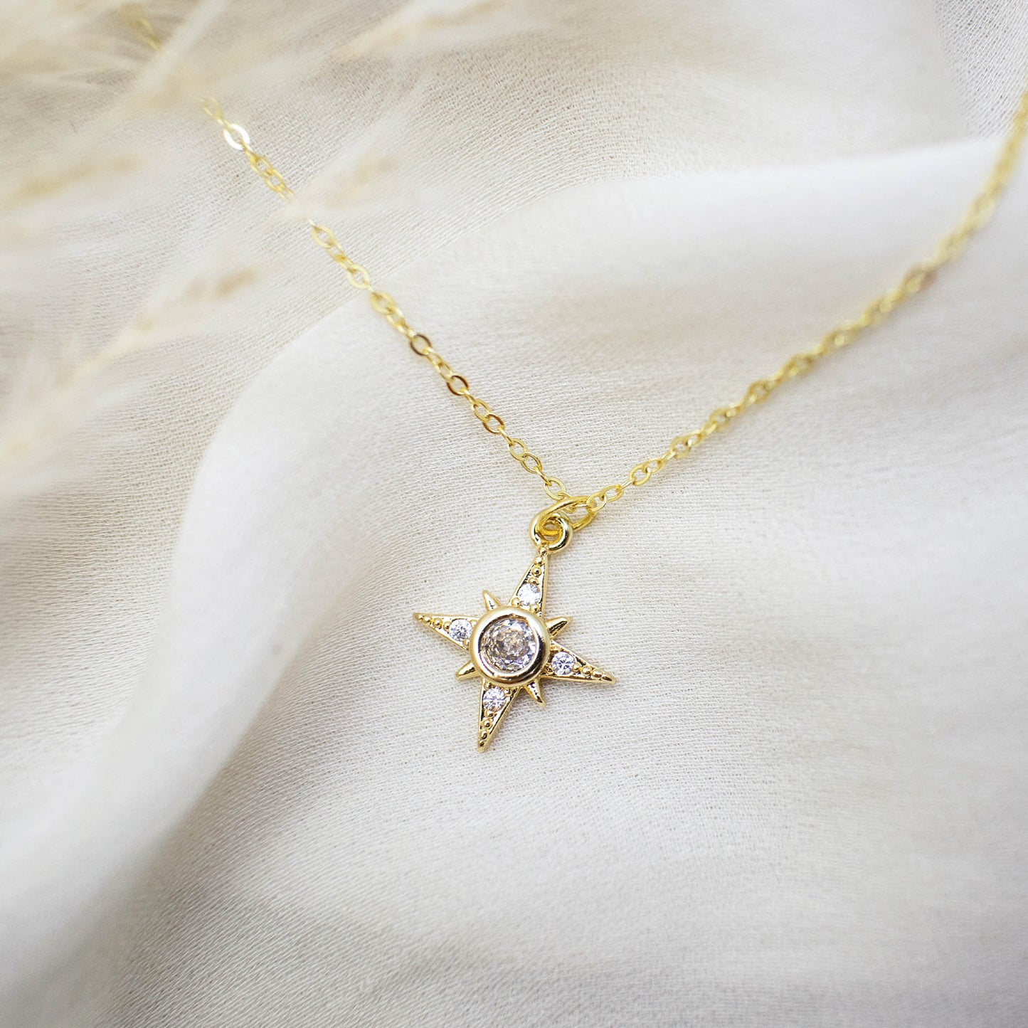 This photo features a thin chain necklace made of 14K gold-plated sterling silver, paired with an octagon zircon charm.