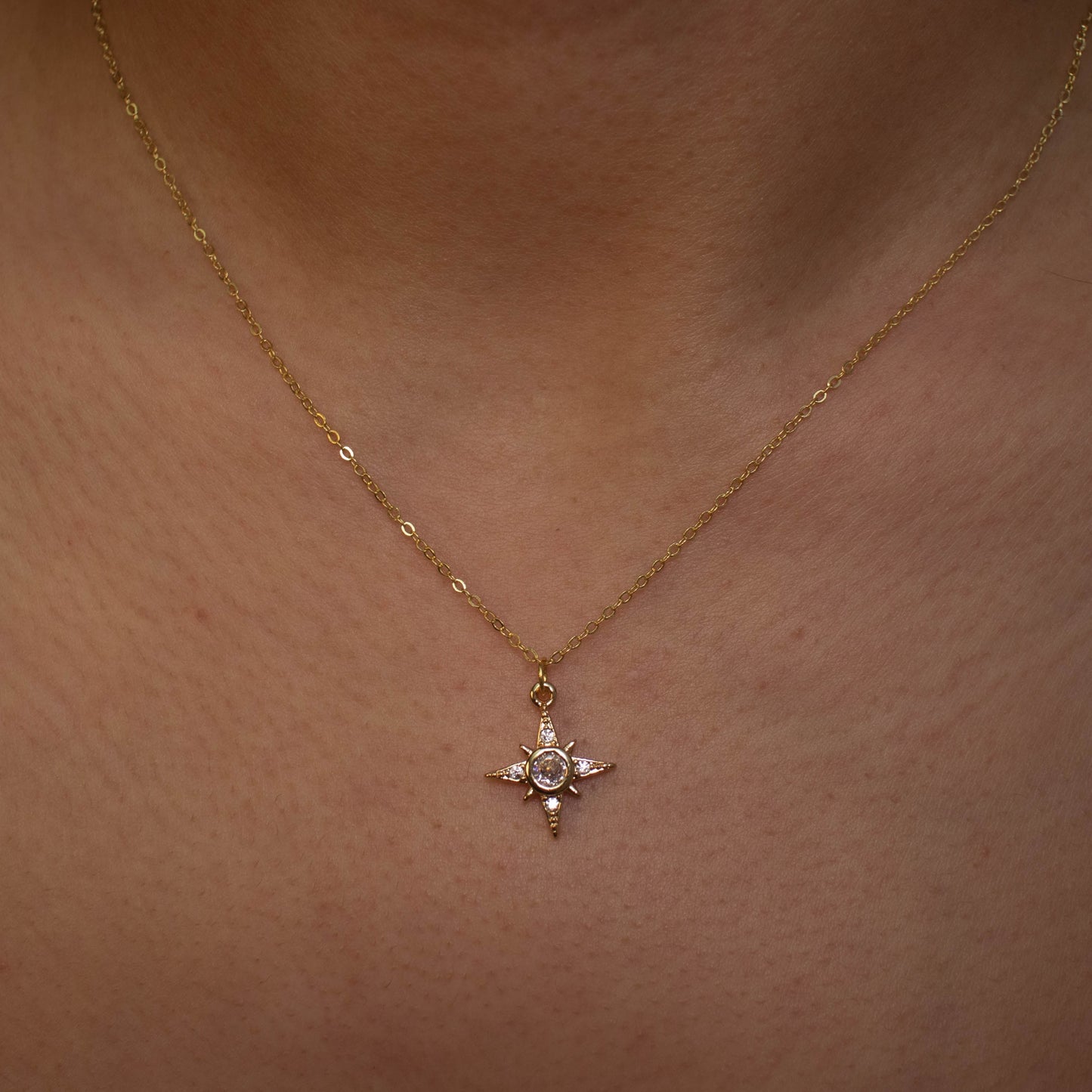  This photo features a thin chain necklace made of 14K gold-plated sterling silver, paired with an octagon zircon charm.